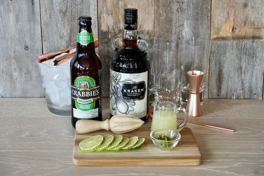 Ingredients for a Dark and Stormy Cocktasil include; dark rum, alcoholic ginger beer, lime juice, lime wedges and lime zest.