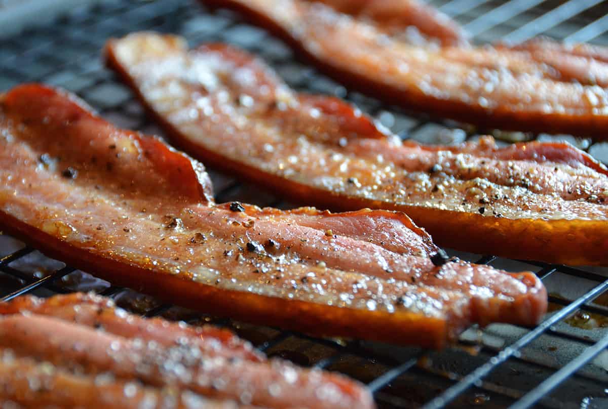 A tray of crispy, oven-roasted, thick-cut slab bacon.