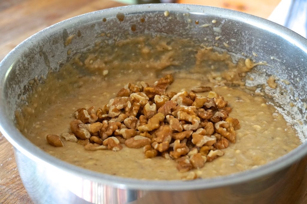Batter in a bowl with chopped walnuts