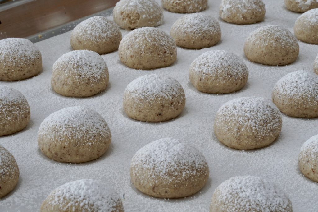 Melt-In-Your-Mouth Pecan Cookies dusted with icing sugar