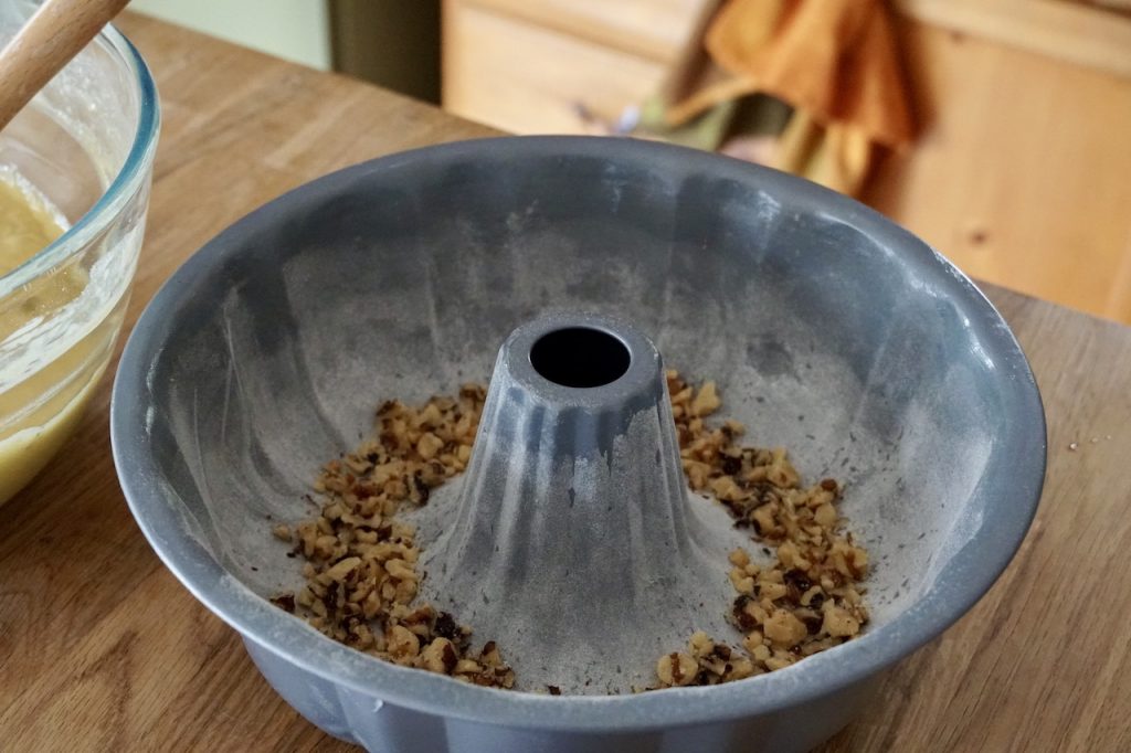 Sprinkle walnuts in the Bundt pan