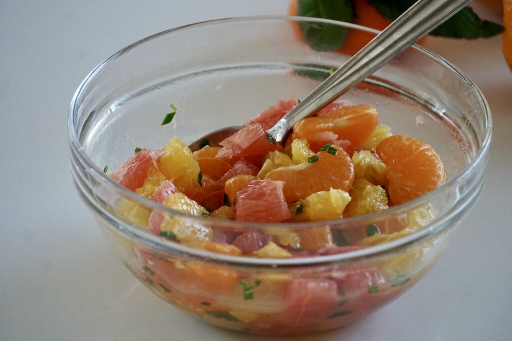 A bowl of citrus salad made using orange, grapefruit and tangerine.