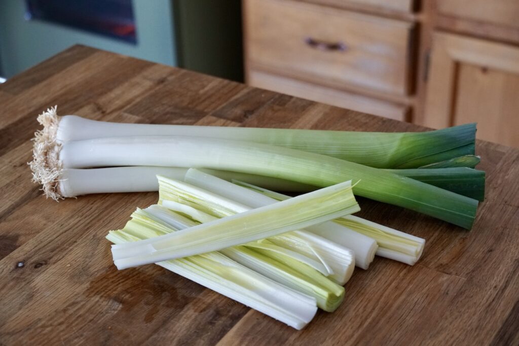 Fresh leeks, trimmed and divided, ready to be braised.