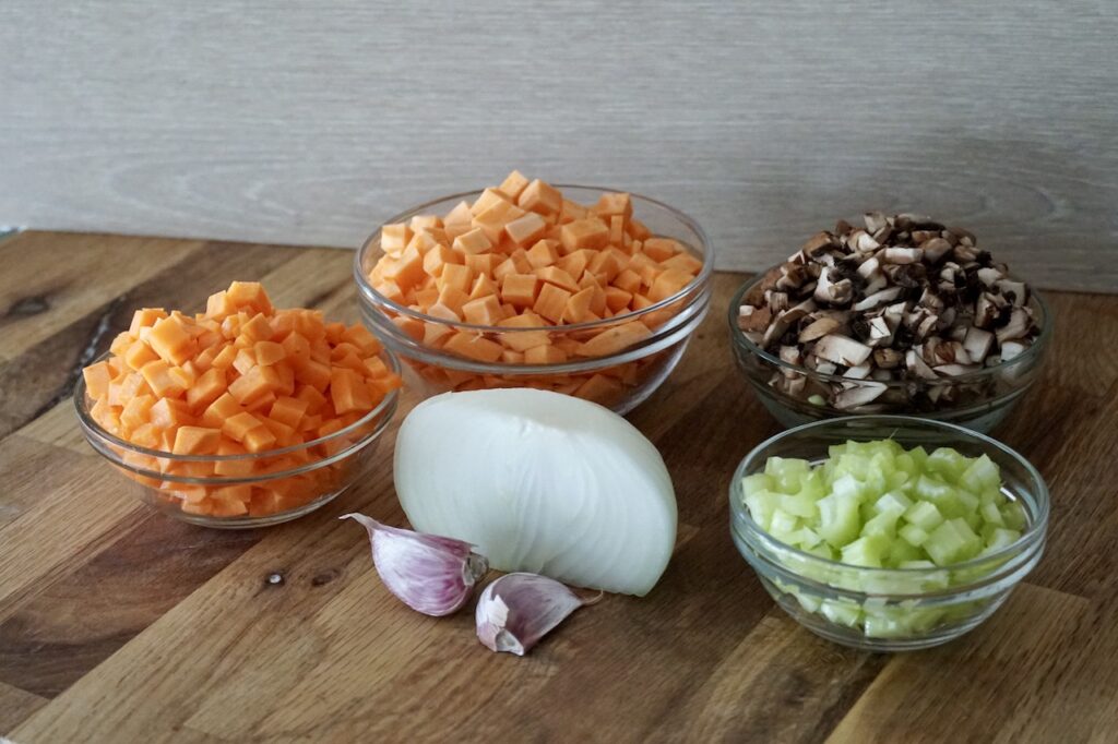 Onion, garlic and chopped mushrooms, carrot, sweet potato and celery all get sauteed.