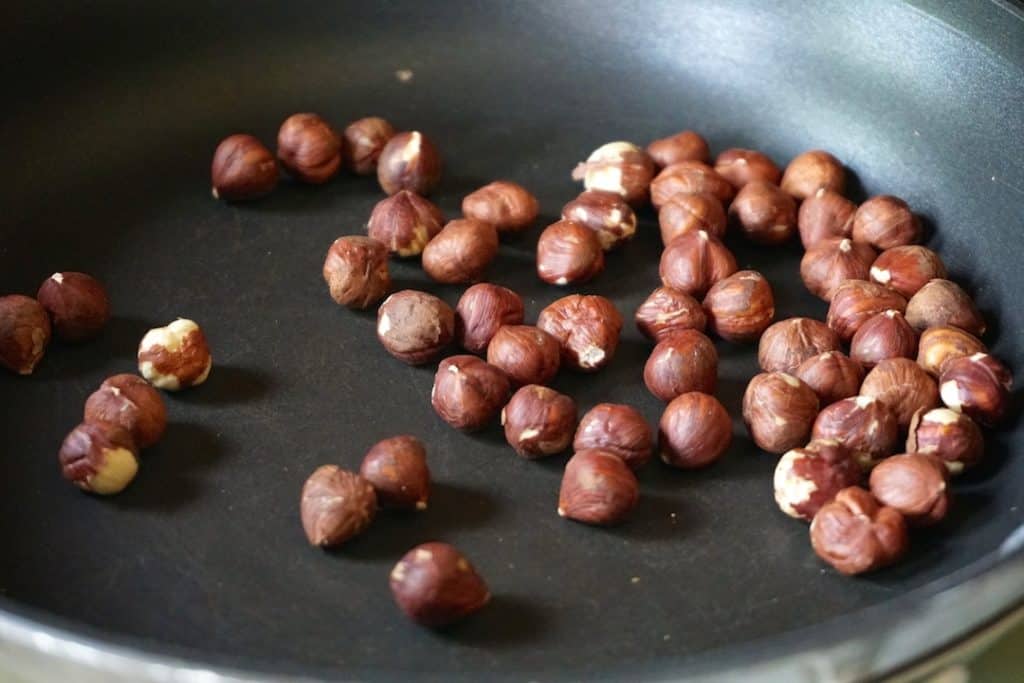 Lightly toasted hazelnuts in the skillet
