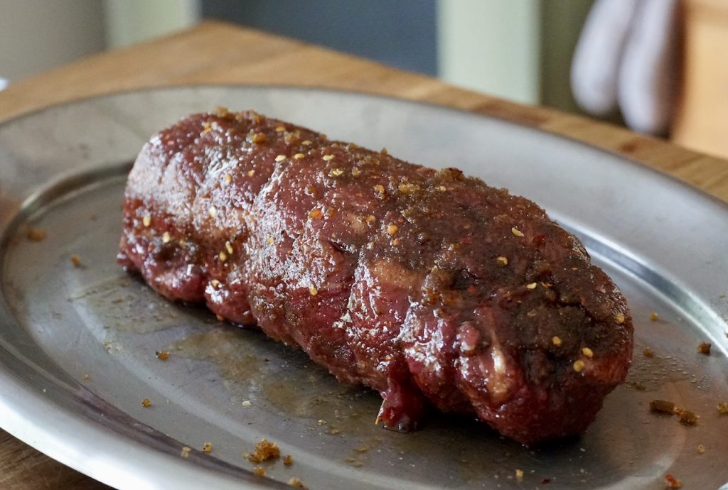 The beef tenderloin rubbed with the sugar, oil, and spices
