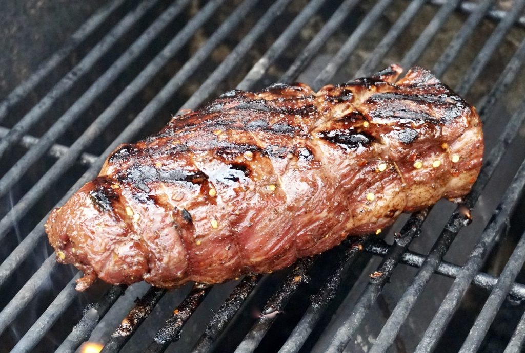 The beef tenderloin cooking on the grill