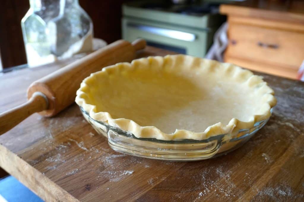 The pie plate lined with the crust 