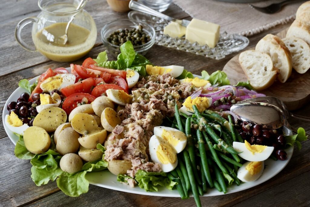TUNA SALAD NIÇOISE served with warmed French baguette.