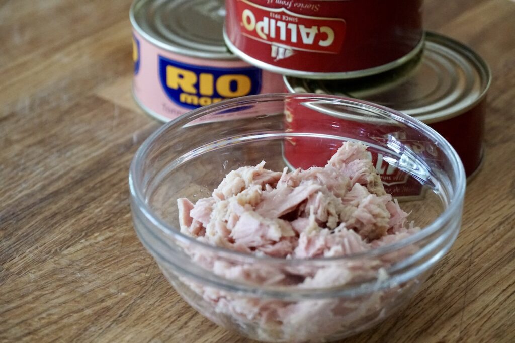 Premium canned tuna, drained and flaked into a small bowl.