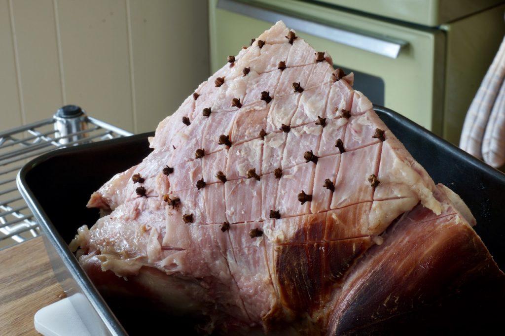 The ham scored and studded with cloves