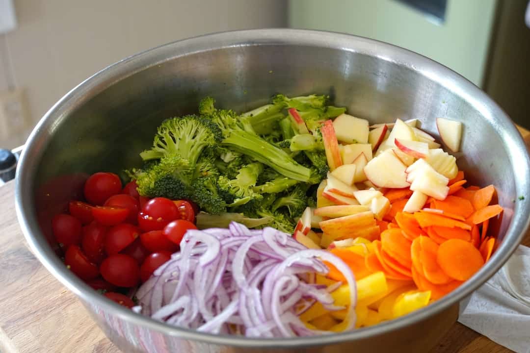 All of the ingredients for The Best Broccoli Salad assembled in a large bowl