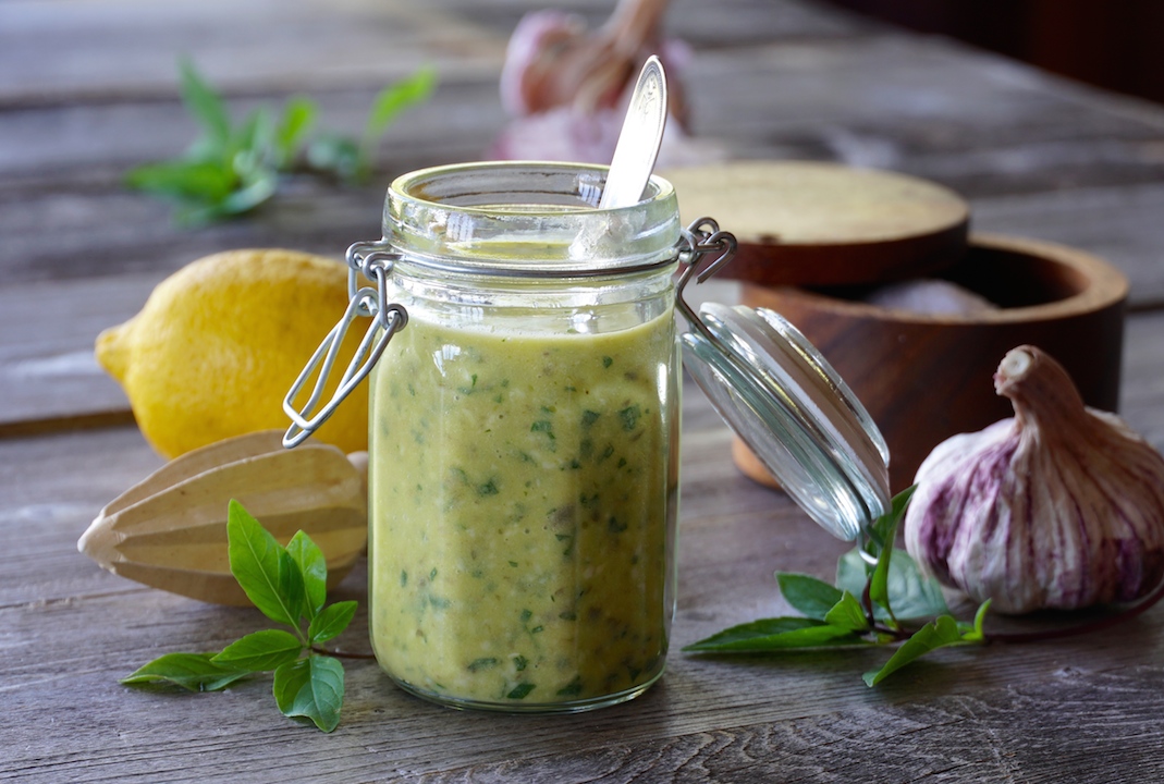 A jar of the marinade made with garlic, basil, Dijon, lemon and extra virgin olive oil...