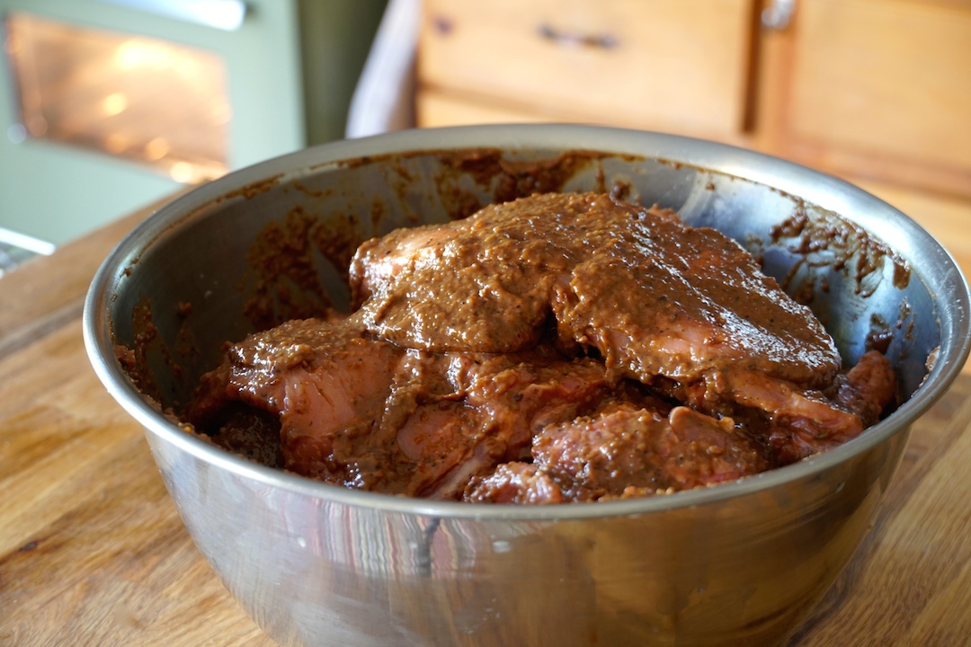 The ribs marinating in a large bowl overnight