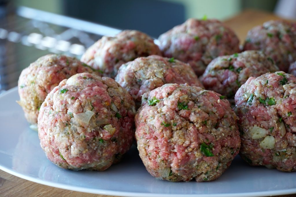 Meat mixture formed into balls ready to be cooked