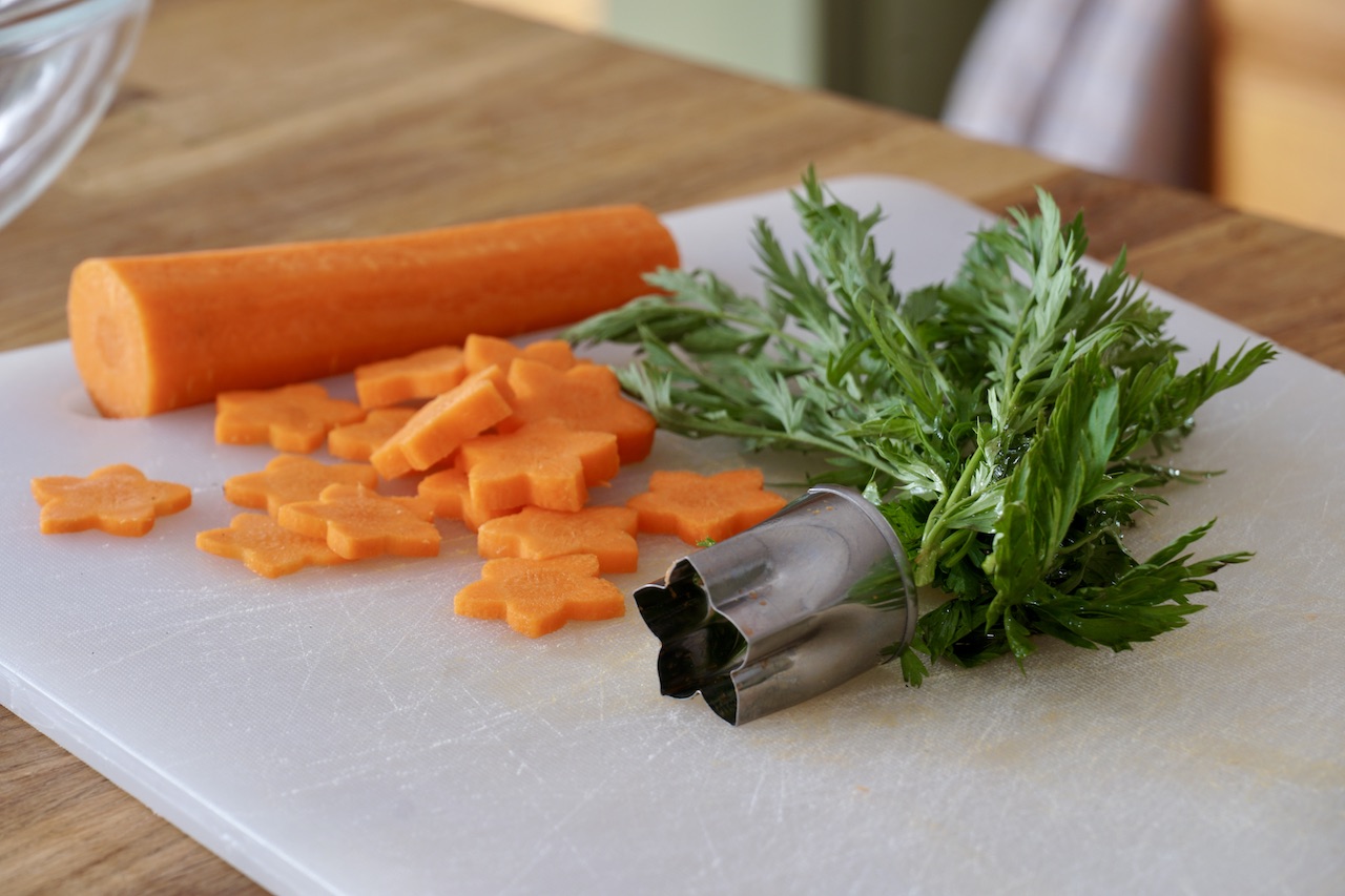 Fancy cut carrots and carrot greens for garnish