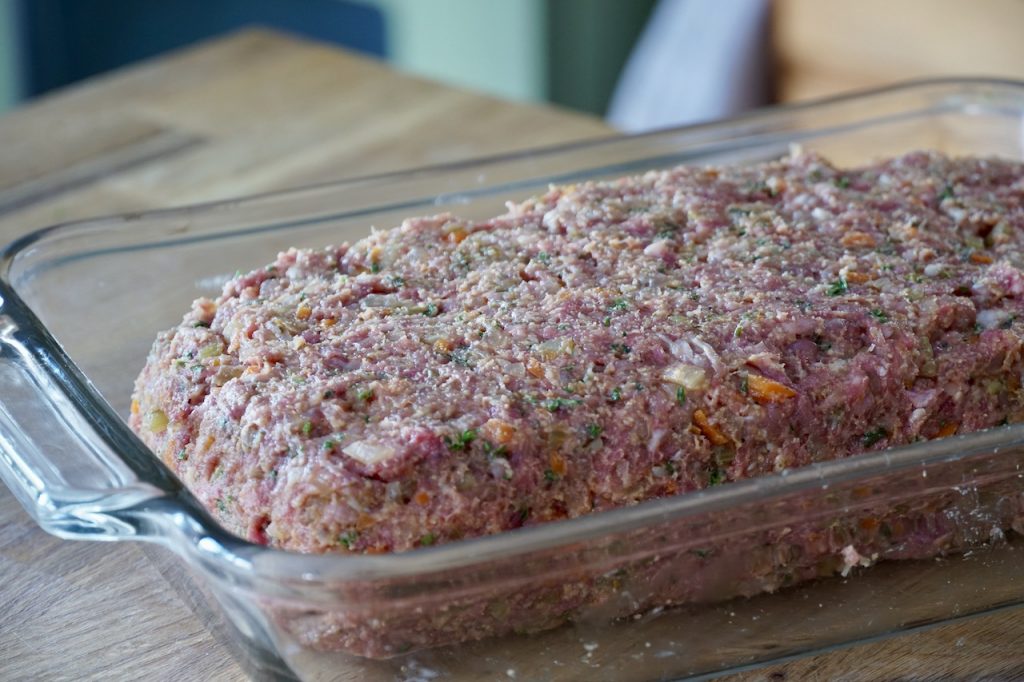 The meatloaf shaped in a casserole dish