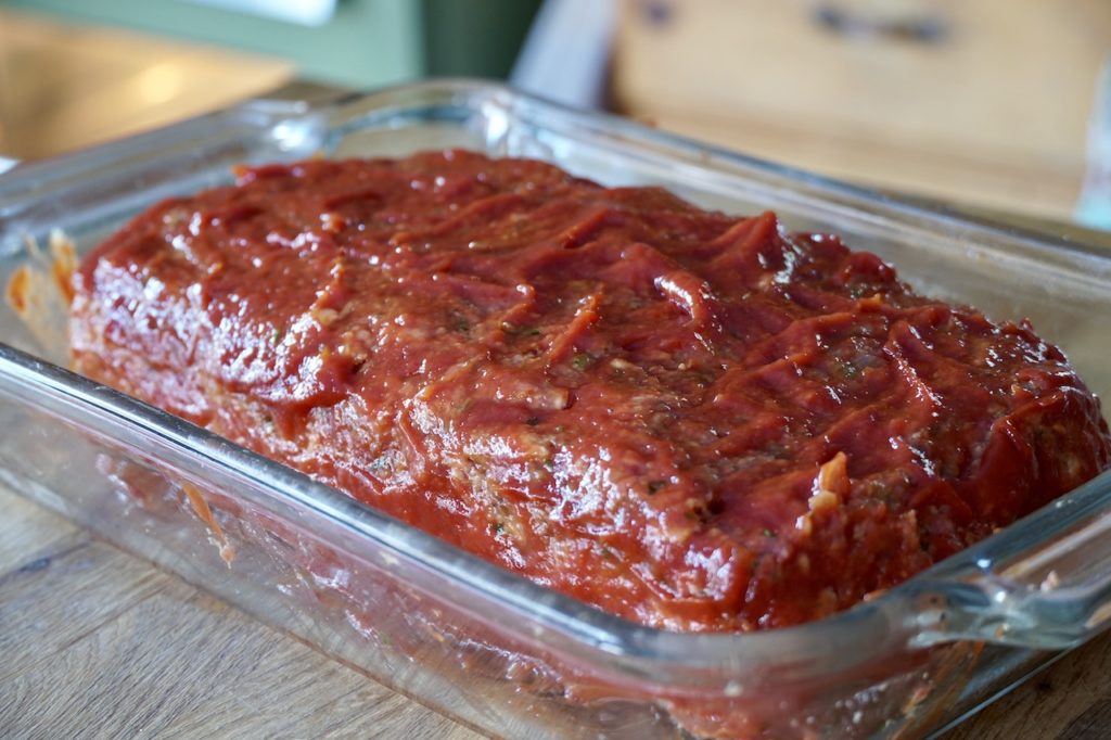Homemade meatloaf coated with tomato sauce
