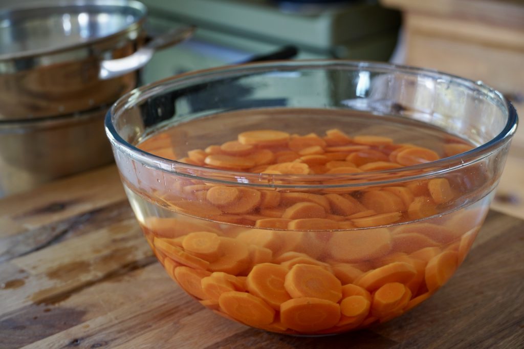 Blanched carrots cooling in iced water