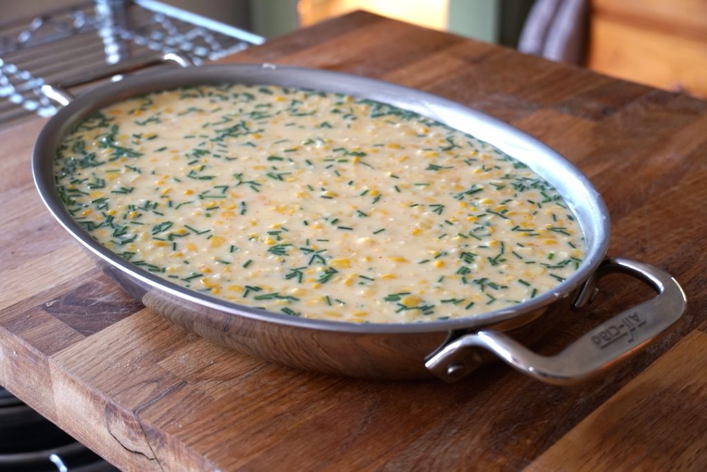 The corn pudding poured into an au gratin dish
