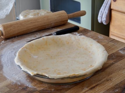 Cheddar Cheese Pie Crust rolled out in the pie plate