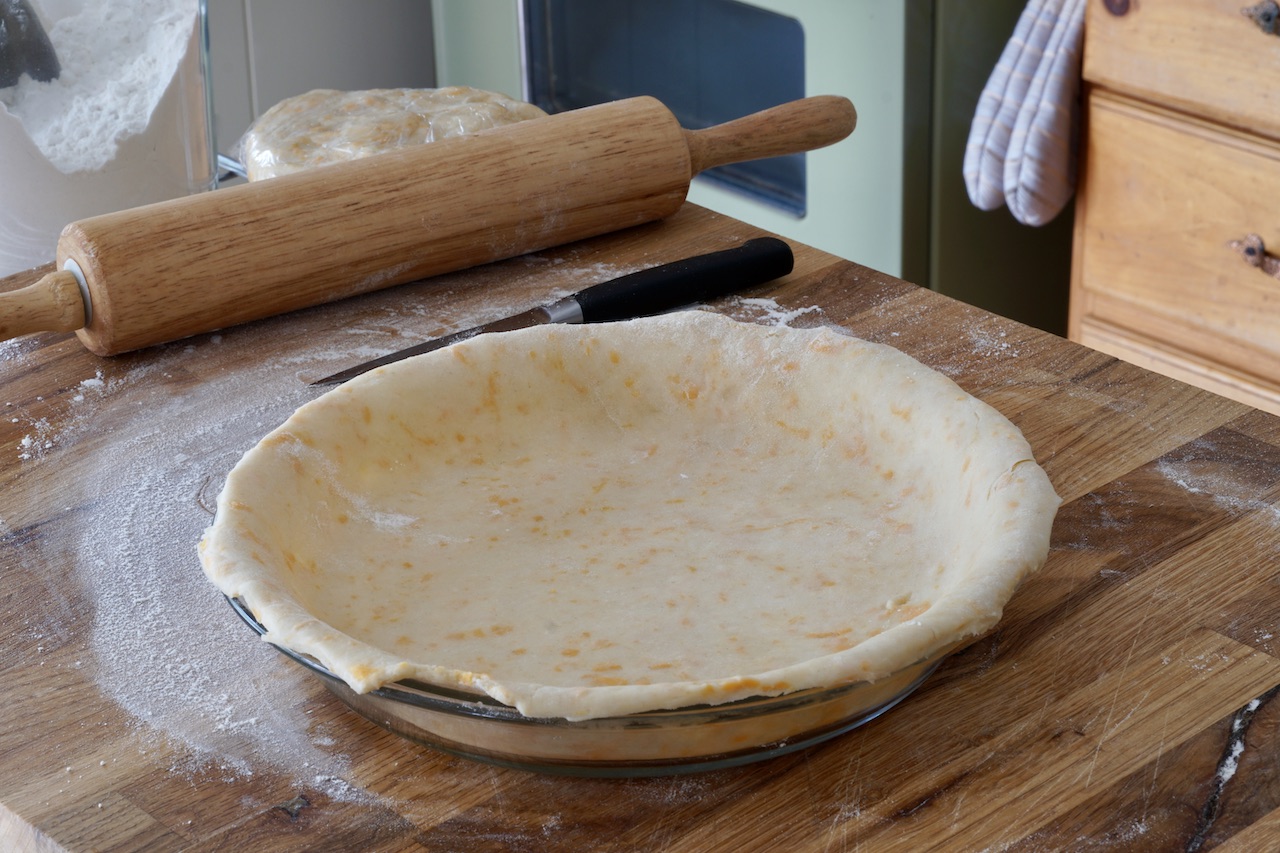 Cheddar Cheese Pie Crust rolled out in the pie plate