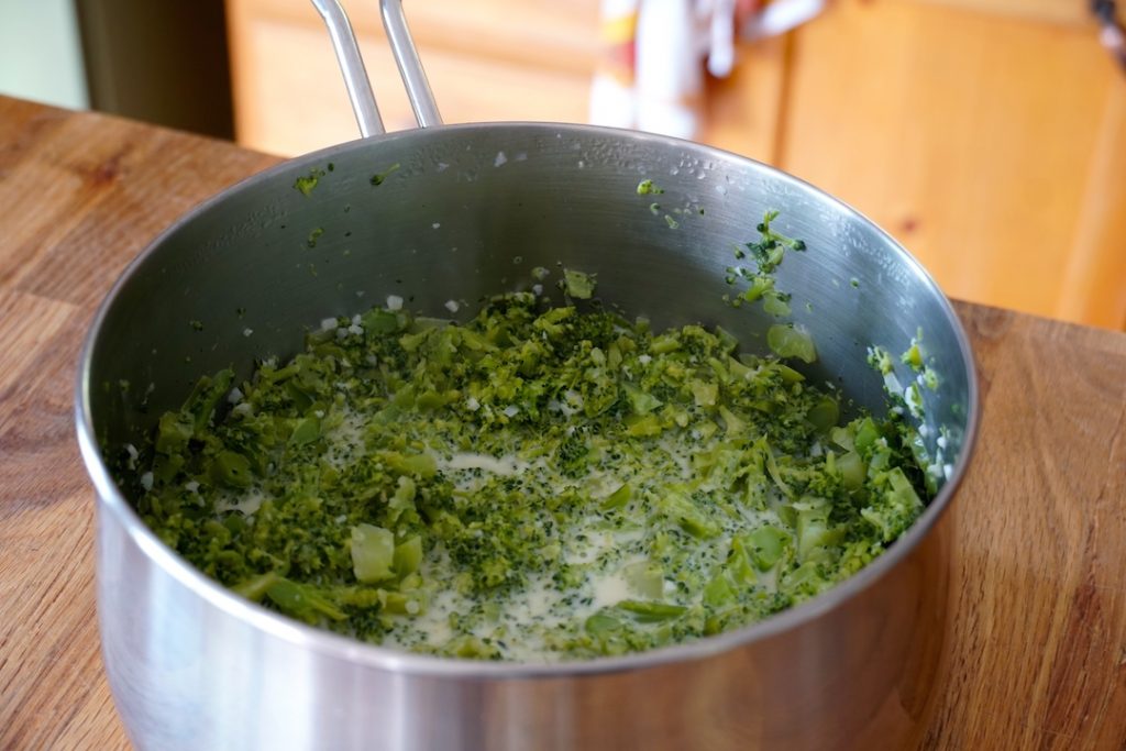 The broccoli gently mashed in the pot