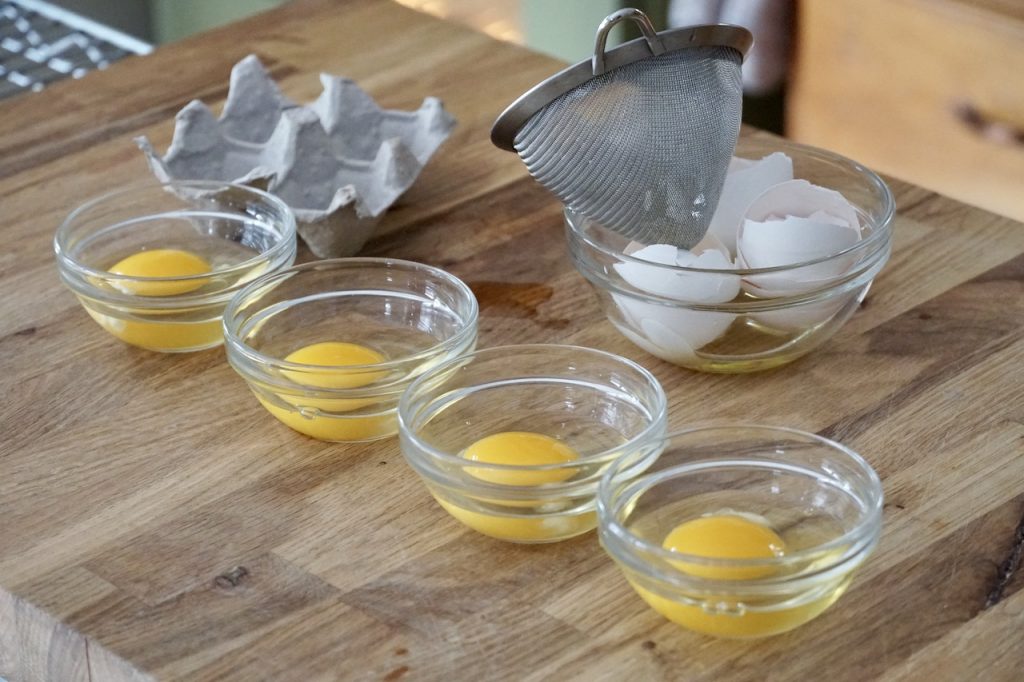 The eggs strained and placed into individual bowls