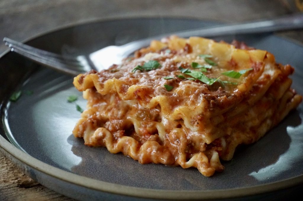 A piece of the homemade meat lasagna served on a plate