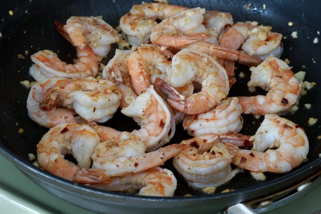 Plump, juicy shrimp cooking in the hot skillet