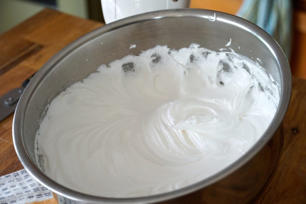 the finished frosting cooling a bit in a bowl