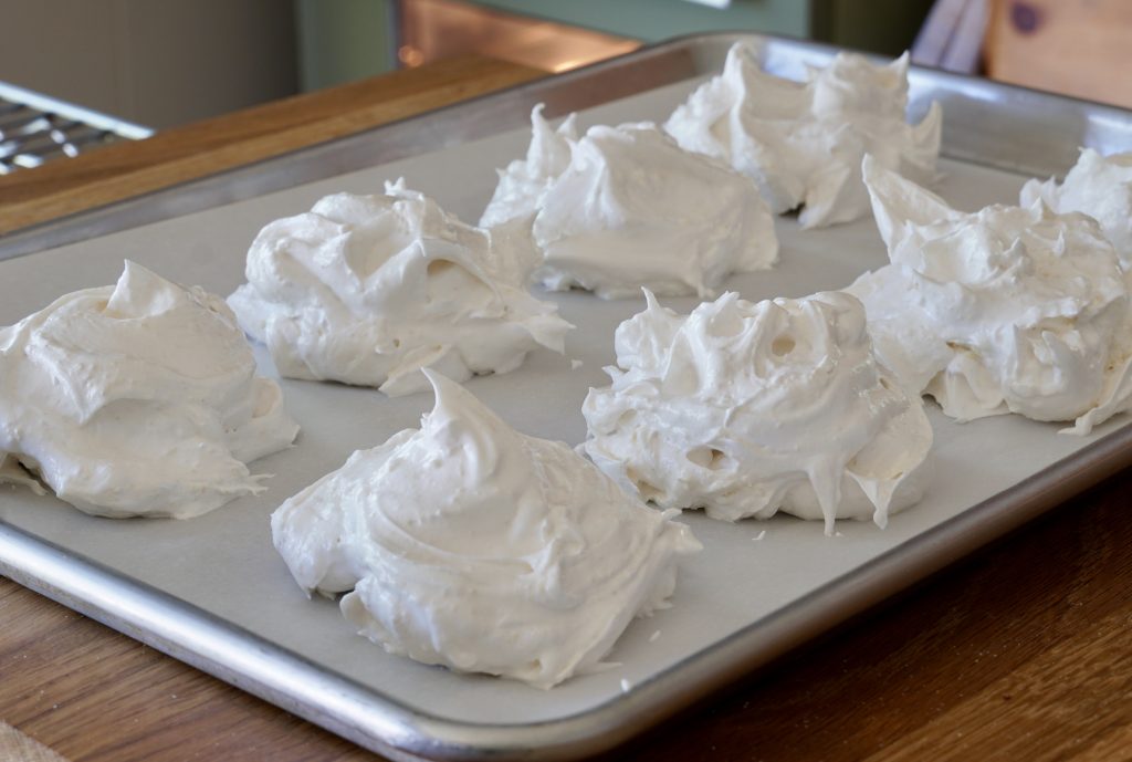 Meringues plopped onto a parchment-lined baking sheet