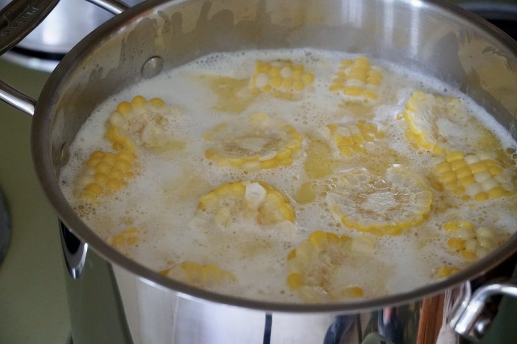 The corn boiling in the milky bath