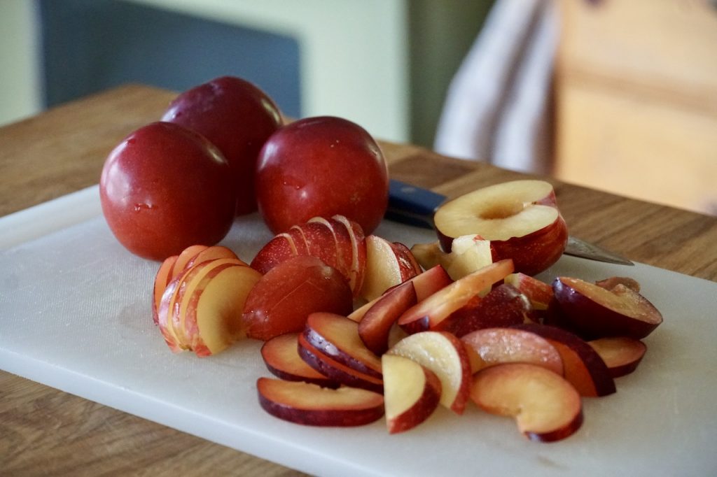 Red plums sliced for the salad