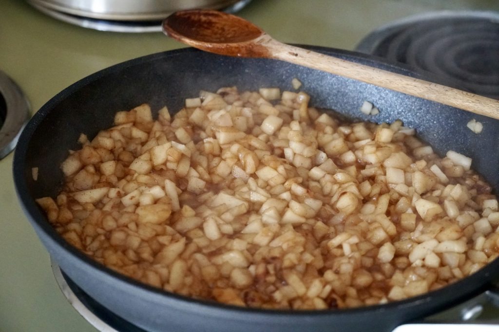 The apple filling cooking in a hot skillet