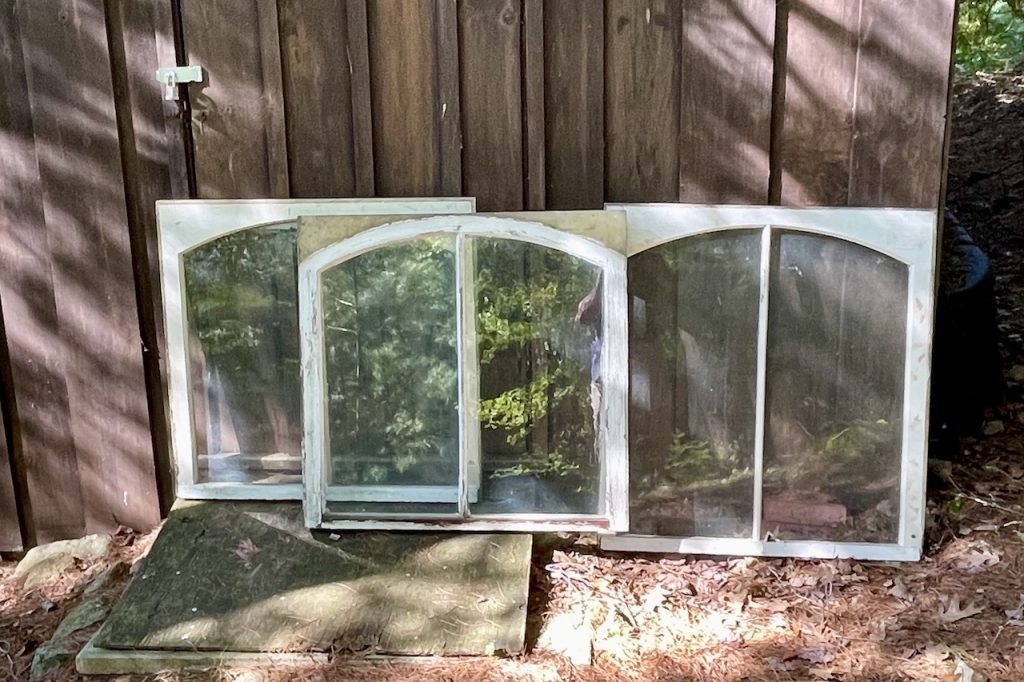 Antique windows added charm and whimsy to the DIY storage shed project.
