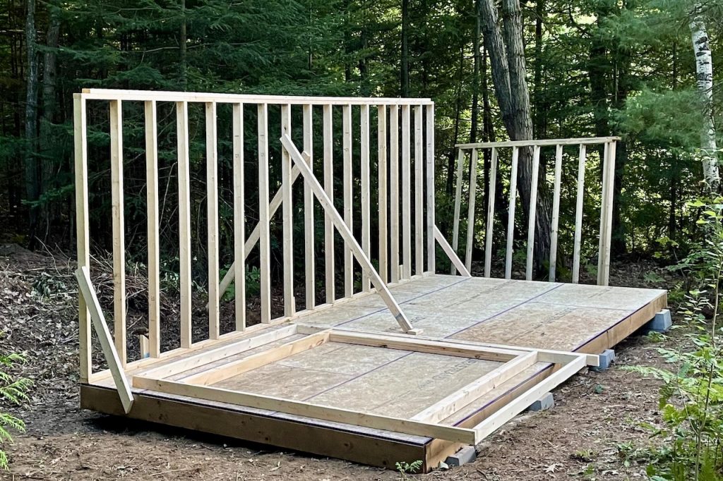 Framing the first wall and securing it in place for the How To Build A Storage Shed.