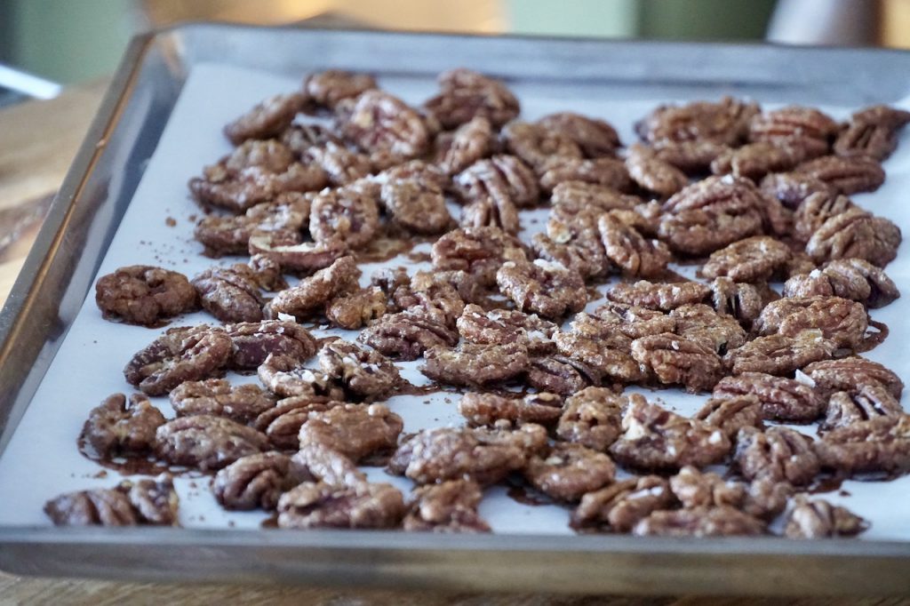 A baking sheet filled with Spicy Candied Pecans