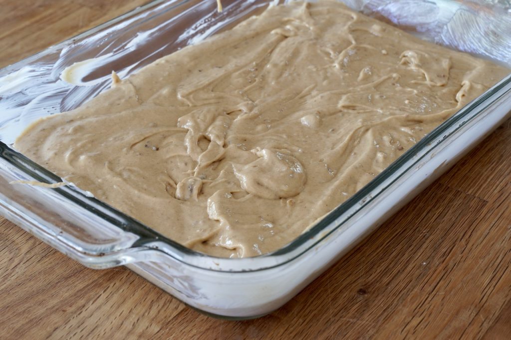 The batter spooned into a glass casserole dish