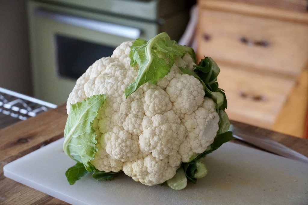 A head of cauliflower ready to be roasted