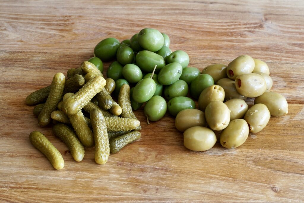 Assorted olives and small pickles gherkins