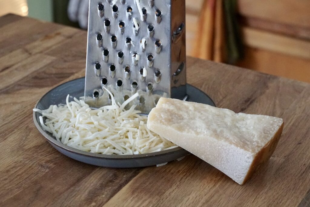 Freshly grated mozzarella and Parmesan cheese.