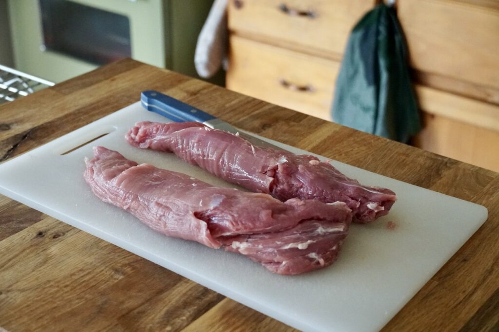 Two pork tenderloins on a cutting board