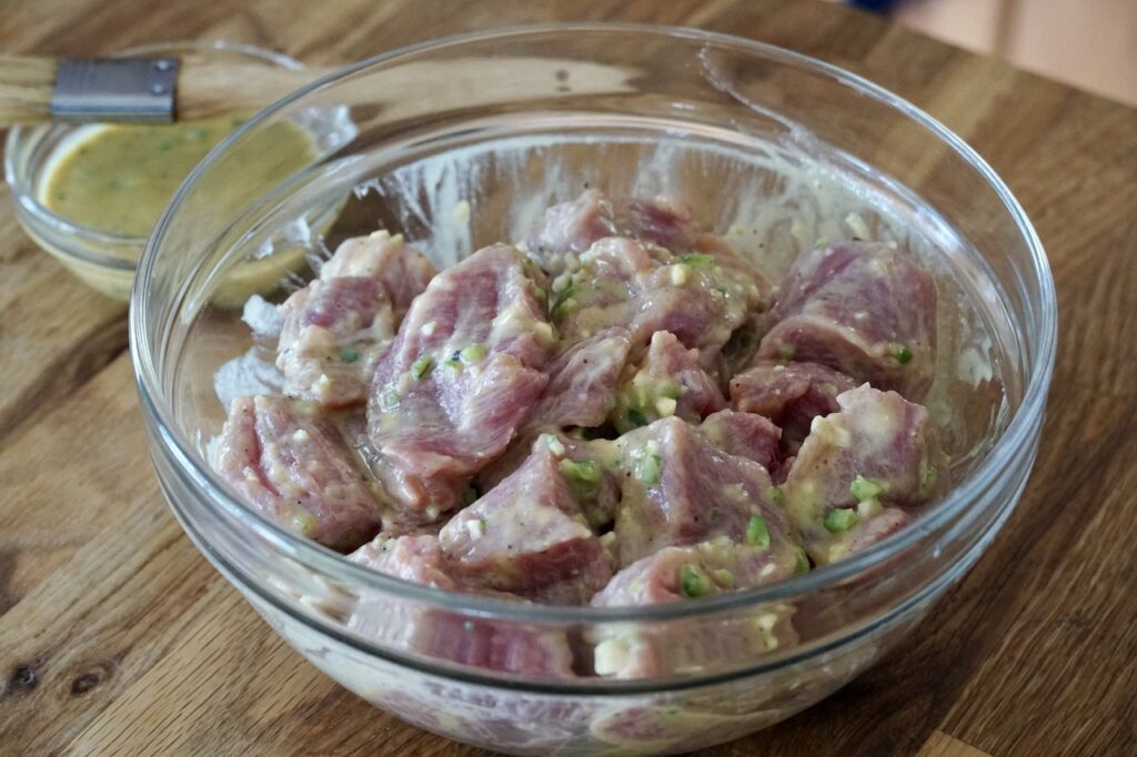 The morsels of pork tossed in the marinade