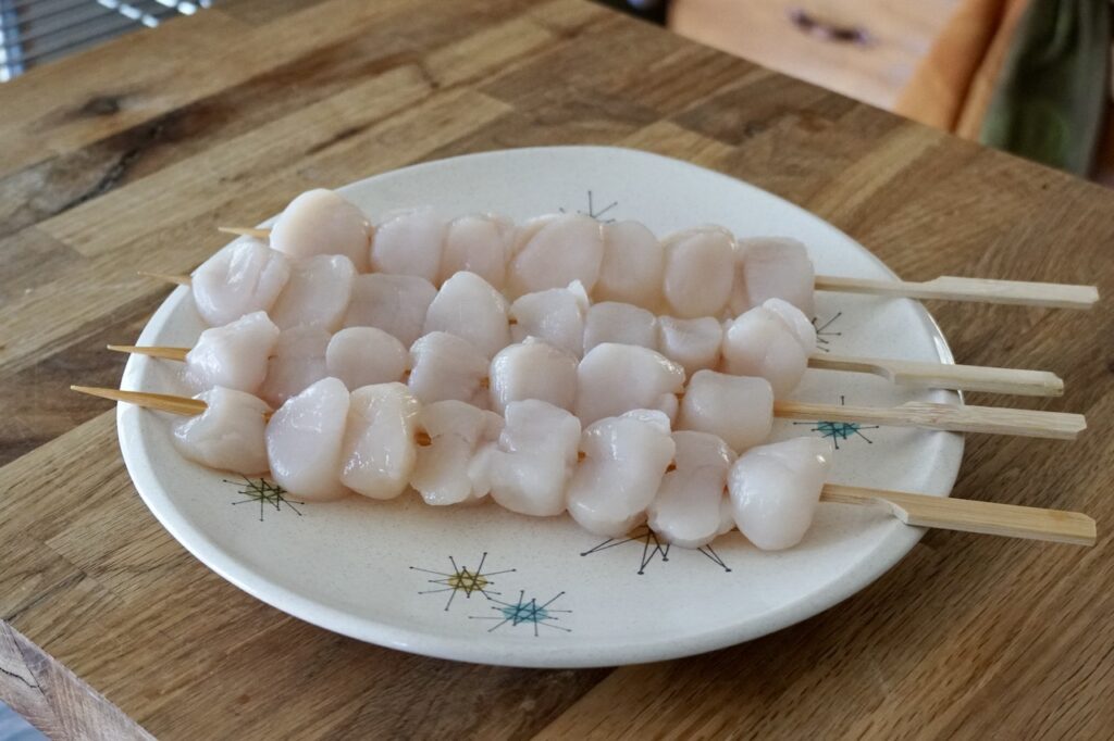 The scallops gathered on bamboo skewers