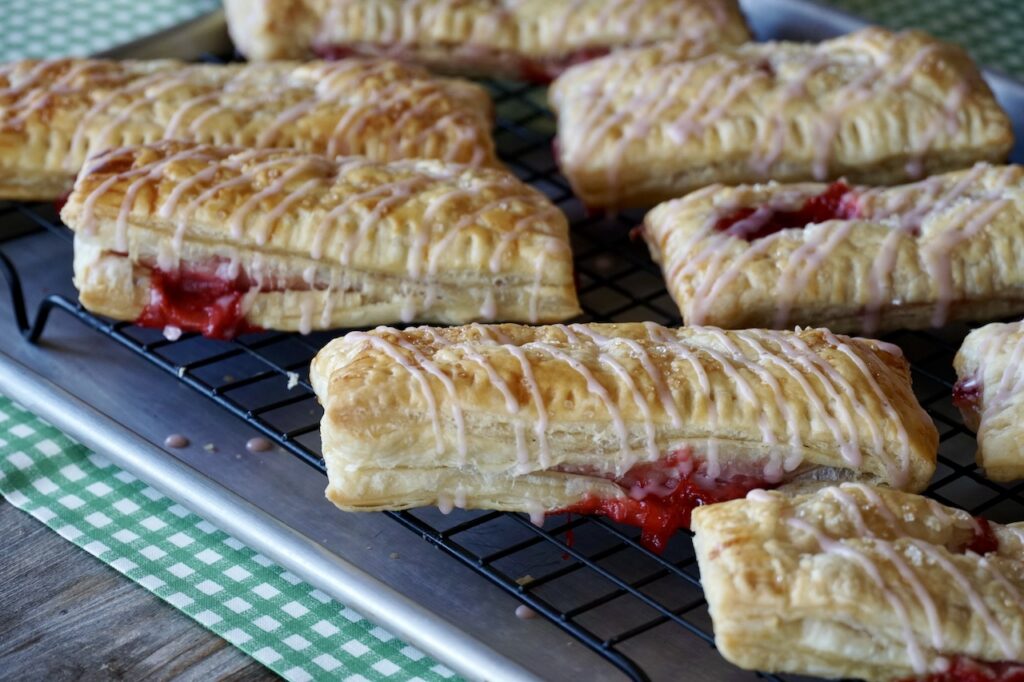 Strawberry turnovers with the glaze applied in a zigzag pattern