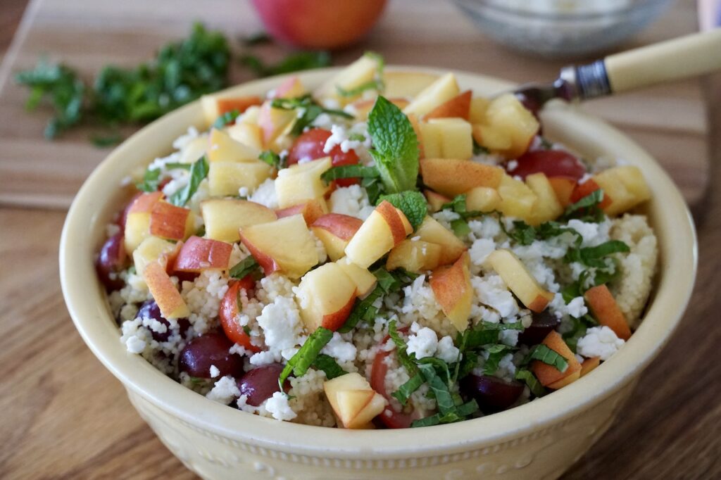 The couscous salad topped with chopped peaches