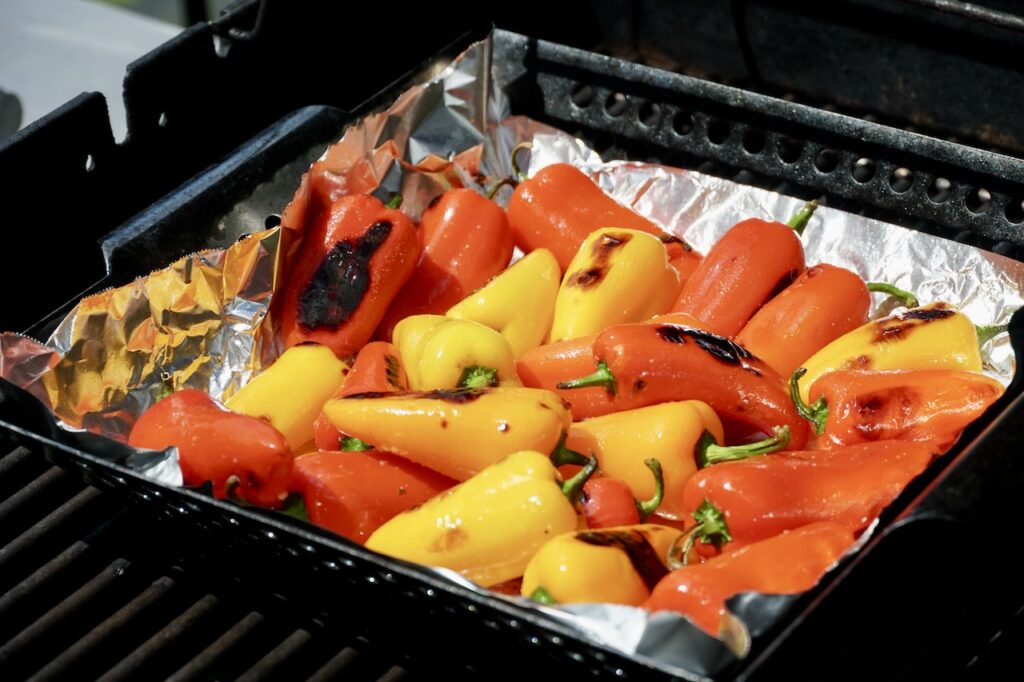 The mini sweet peppers blistered on the hot grill