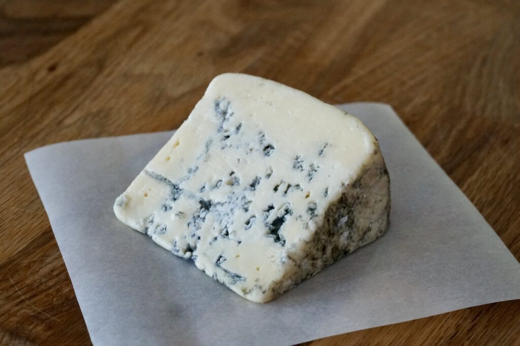 A wedge of aged blue cheese