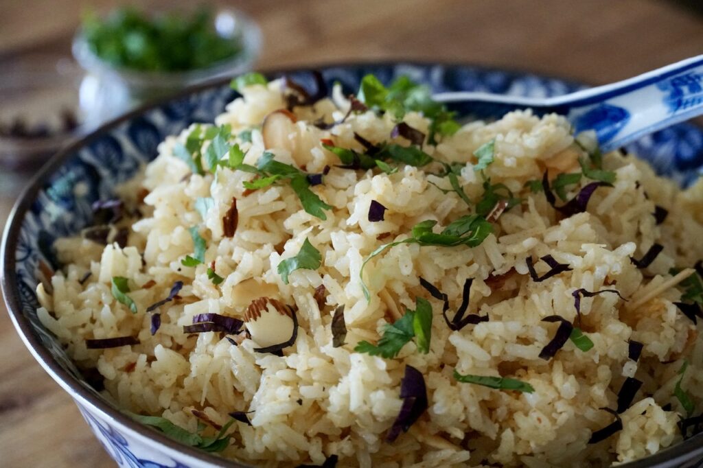 Nutty Coconut Rice garnished with chopped cilantro and Thai basil